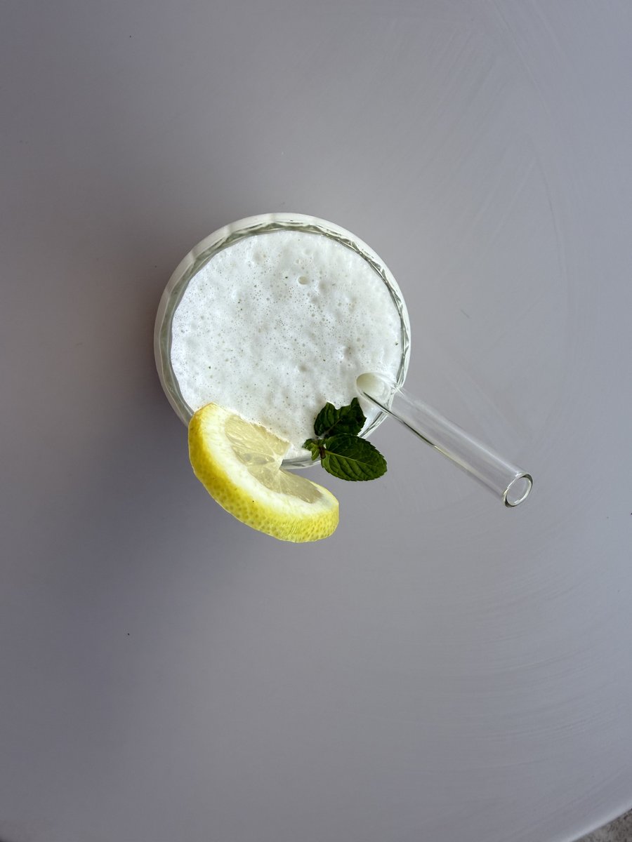 Overhead view of the mojito protein shake with lime and mint garnish